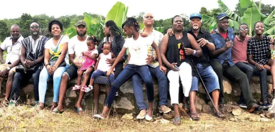  ??  ?? The Barrett’s on a farm near Abuja - Lindsay is fourth from right with wife, Asamaere; Rae is sitting sixth from right with Evi (daughter of Ejiro) on his knee. All others pictured here are children and grandchild­ren of Lindsay, but three...