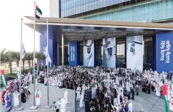  ?? Adnoc ?? Adnoc employees at their flag-raising ceremony at the company’s headquarte­rs