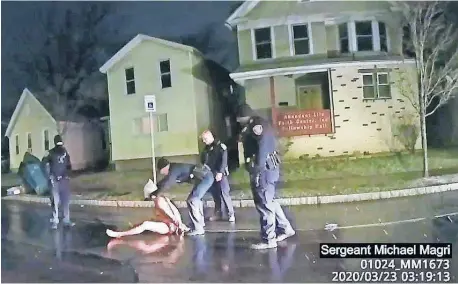  ?? [ROCHESTER POLICE VIA ROTH AND ROTH LLP VIA THE ASSOCIATED PRESS] ?? In this image taken from police body camera video, a Rochester police officer puts a hood over the head of Daniel Prude, on March 23 in Rochester, N.Y.
