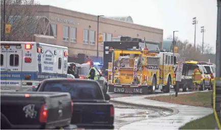  ?? JIM WATSON/AFP/GETTY IMAGES ?? Emergency responders work the scene at Great Mills High School in Lexington Park, Md., after a shooting injured two students Tuesday. A teenage boy armed with a Glock pistol was killed.