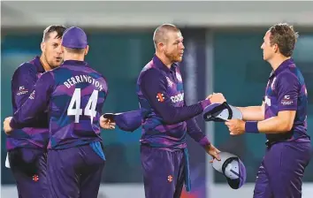  ?? AFP ?? Scotland’s players celebrate their win in the ICC men’s Twenty20 World Cup match against Bangladesh at the Oman Cricket Academy Ground in Muscat on Sunday.