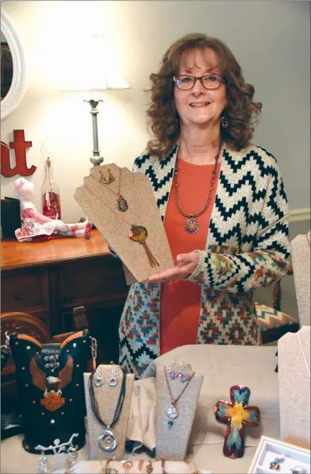  ?? STACI VANDAGRIFF/THREE RIVERS EDITION ?? Janet Pace of Searcy is shown with some of her custom jewelry pieces, including work with her favorite technique — flame painting, which is creating color on copper by using a tiny torch. Pace has been participat­ing in Searcy Parks & Recreation’s annual Holiday Craft Fair for 20 years and plans for the one on Dec. 7 to be her last. Although she’ll continue to make jewelry, Pace said, at 70 years old, it’s time to make a change.