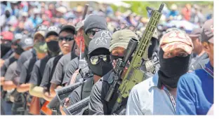  ?? REUTERS ?? Extreme cartel violence has led to the formation of vigilante groups like ‘El Machete’, pictured here in Chiapas, Mexico, in this July 18 photo.