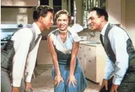  ??  ?? Donald O’Connor (from left), Debbie Reynolds and Gene Kelly figure out how to turn a silent flop into a hit musical in the 1952 MGM classic “Singin’ in the Rain.” HANDOUT