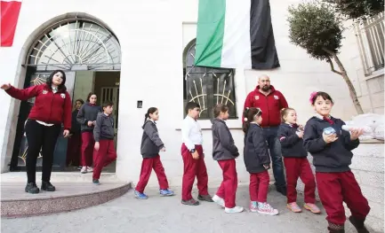  ??  ?? Iraqi Christian students exit a school building in Amman. (File photo/AFP)