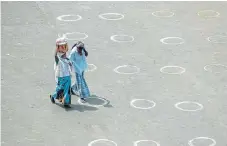  ?? /AFP ?? Keeping your
distance: Circles marked for social distancing at a temporary market in Chennai, India.