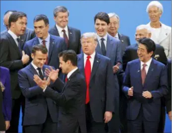  ?? PABLO MARTINEZ MONSIVAIS - THE ASSOCIATED PRESS ?? President Donald Trump and other heads of state react to Mexico’s President Enrique Pena Neto, throwing his hands up, being the last one to arrive for the family photo at the G20 summit, Friday, Nov. 30, in Buenos Aires, Argentina.