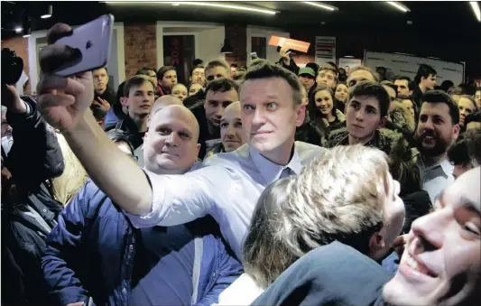  ?? PICTURES: AP ?? Russian opposition leader Alexei Navalny takes a selfie with his supporters at the opening of his campaign office in St Petersburg, Russia, on Saturday. Navalny, one of Russia’s most prominent opposition figures, faces an uncertain future after he was...