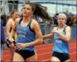  ?? BOB RAINES — DIGITAL FIRST MEDIA ?? North Penn’s Mikaela Vlasic takes the baton from Natalie Kwortnik to start the anchor leg of the girls 4 x 800 meter relay at the Jim Kelly Invitation­al Saturday.