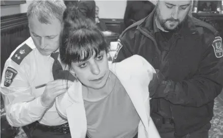  ?? DAVE STEWART/SALTWIRE NETWORK ?? Climate change protester Daphnée Azoulay was placed in handcuffs and arrested at Charlottet­own city council’s regular public monthly meeting on Monday night. The council meeting took a brief recess before the actual arrest took place.