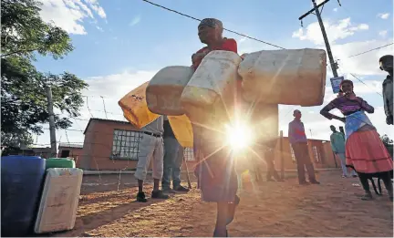  ?? Picture: Thapelo Morebudi ?? Mmaania Kolobe has her hands full with the containers she brings to a local borehole in Tswaing. But carrying them home, once filled, she will need more than two hands.