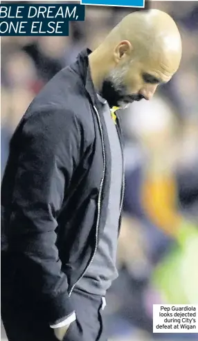  ??  ?? Pep Guardiola looks dejected during City’s defeat at Wigan