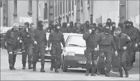  ?? PASCAL PARROT REUTERS ?? Masked French special unit policemen return to their barracks after a 30-hour siege on Merah’s home ended in a hail of bullets as he emerged firing from a balcony.