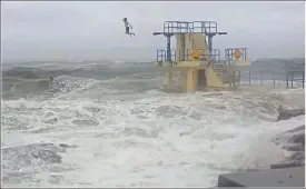  ??  ?? MADNESS: The two young men jumped several times off the Salthill diving tower into the wild Atlantic at the height of the worst storm in 50 years