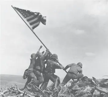  ?? JOE ROSENTHAL/AP ?? WORLD WAR II: Six Marines from the 28th Regiment, 5th Division raise the U.S. flag on Feb. 23, 1945, atop Mount Suribachi during the Battle of Iwo Jima. Three of the Marines were later killed. The photo won the Pulitzer Prize.