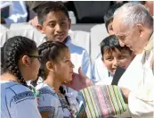  ?? — AFP ?? Pope Francis receives gift from Mexican children at the end of his weekly general audience in St. Peter’s square, the Vatican, on Wednesday.