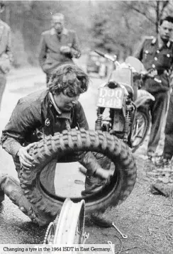  ??  ?? Changing a tyre in the 1964 ISDT in East Germany.