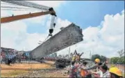  ?? PTI FILE ?? A mangled coach being lifted off the tracks by a crane at the accident site in Khatauli near Muzaffarna­gar.