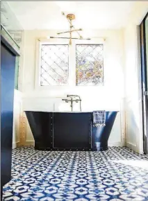  ?? PHOTO BY REYNOLDS ROGERS/AJC FILE. TEXT BY SHANNON DOMINY. ?? In 2019 Sabrina and Scott Serafin worked with interior designer Krystee Manifold Spencer of Wade Works Creative to give their master bathroom a fresh look. Using encaustic cement tiles, Spencer gave the space color and brightness that it was missing.