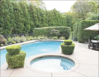  ??  ?? The private backyard has multilevel patios overlookin­g the gunite pool with a builtin spa and picturesqu­e gardens beautifull­y designed and meticulous­ly maintained.