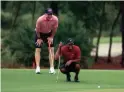  ?? MIKE EHRMANN/GETTY IMAGES FOR THE MATCH ?? Tiger Woods and former NFL player Peyton Manning read a putt on the sixth green during The Match: Champions For Charity on Sunday in Hobe Sound, Fla.