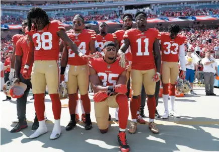  ?? AP FILE PHOTO ?? San Francisco 49ers safety Eric Reid kneels in front of teammates during the national anthem before an NFL football game against the Carolina Panthers in Santa Clara, Calif. on Sept. 10.