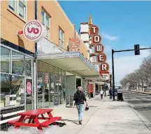  ??  ?? The strip of storefront­s beneath the Tower Theatre marquee have filled up with quality dining options.