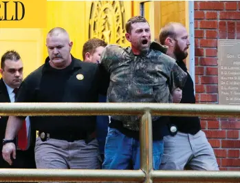  ?? JERRY LARSON / WACO TRIBUNE-HERALD VIA AP ?? Gordon Coble is led out of the of the Texas State Penitentia­ry in Huntsville, Texas, Thursday during his father’s execution. Coble and 21-year-old Dalton Coble were arrested on charges of resisting arrest and disorderly conduct.