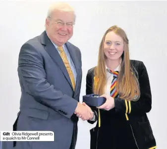  ??  ?? Gift Olivia Ridgewell presents a quaich to Mr Connell