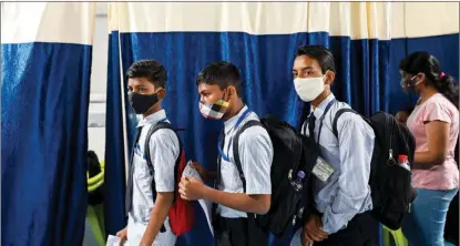  ?? PUNIT PARANJPE / AFP ?? Students line up to receive a COVID-19 vaccine at a center in Mumbai on Jan 8. Indian authoritie­s have begun vaccinatin­g teenagers aged from 15.