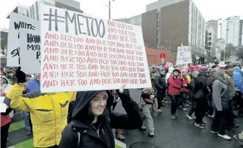  ?? TED S. WARREN/ AP ?? A marcher carries a sign with the popular Twitter hashtag # MeToo as she takes part in a Women's March in Seattle on Jan. 20.