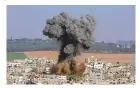  ?? HATEM MOUSSA/ASSOCIATED PRESS ?? Gaza City is hit by an Israeli airstrike on Tuesday. Violence between Israel and Hamas has escalated. The center of attention is Jerusalem, held by both Jews and Palestinia­ns as sacred.