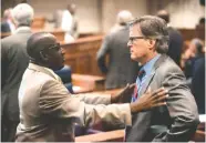  ??  ?? Bobby Singleton, D-Greensboro, left, speaks to Bill Hightower, R-Mobile, during discussion of the lottery bill on Thursday at the State House in Montgomery, Ala.