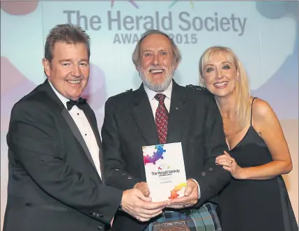  ??  ?? WINNER: George Berstan of NSPCC Childline was presented with the 2015 Unsung Hero Award by Gordon Mason, watched on by host Cathy Macdonald.