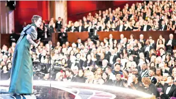 ??  ?? Colman accepts her Best Actress Oscar award. — Reuters photo