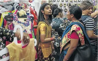  ??  ?? Darshana Govindram, 24, goes shopping to prepare for Diwali festival in Durban. “Everything is so close-knit and close by and everyone just gets along with everybody,” she says of life in Chatsworth, the Durban suburb that the apartheid government designed to segregate the city’s large Indian community.