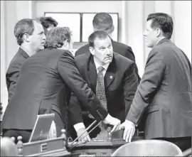  ?? Rich Pedroncell­i
Associated Press ?? REPUBLICAN ASSEMBLY MEMBERS, including Brian Dahle of Bieber, center, huddle before the Assembly takes up the state budget at the Capitol.