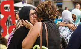  ?? FRANCISCO SECO / AP ?? Families of the young men believed responsibl­e for the attacks in Barcelona and Cambrils gather along with members of the local Muslim community to denounce terrorism and show their grief in Ripoll, Spain, on Saturday.