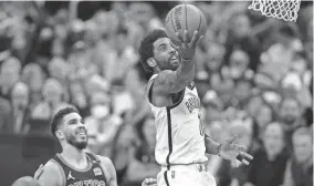  ?? STEVEN SENNE/AP ?? Nets guard Kyrie Irving drives to the basket past Celtics forward Jayson Tatum during Game 1 of a first-round playoff series Sunday in Boston. The Celtics won 115-114.