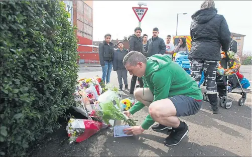  ??  ?? COMMUNITY IN SHOCK: Members of the public lay floral tributes to knife-attack victim Asad Shah in Shawlands yesterday. Picture: Colin Mearns