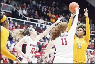  ??  ?? Tennessee’s Jazmine Massengill, (right), shoots against Stanford’s Ashten Prechtel (11) and Lexie Hull (12) during the first half of an NCAA college basketball game on Dec 18, in Stanford, California. (AP)