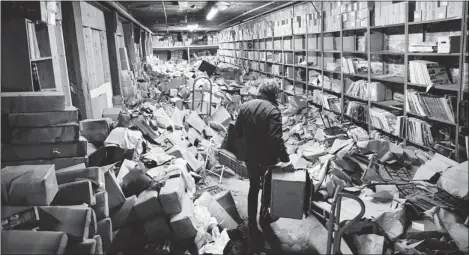  ??  ?? Norton Records’ warehouse was severely flooded by Sandy in November. The company’s owners acted fast to salvage vinyl records; CDs were destroyed.