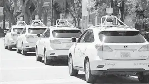  ?? ERIC RISBERG/AP 2014 ?? A row of Google self-driving cars sit outside the Computer History Museum in Mountain View, Calif.