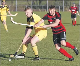  ?? Photo: Stephen Lawson ?? Inveraray’s Lewis MacNicol shields the ball from Oban Camanachd’s Willie Neilson during last Saturday’s friendly match at Mossfield which the red and blacks won 3-0.
