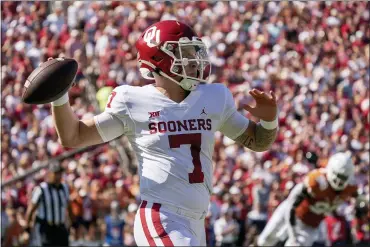  ?? JEFFREY MCWHORTER — THE ASSOCIATED PRESS ?? Oklahoma quarterbac­k Spencer Rattler (7) throws downfield against Texas during the first half of an NCAA college football game at the Cotton Bowl, Saturday, Oct. 9, 2021, in Dallas.