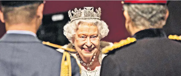  ??  ?? The Queen talks to military members following the State Opening of Parliament