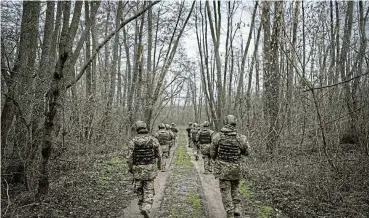  ?? /Reuters ?? Territory: New Ukrainian recruits on an exercise as Russian forces begin to make advances in the east of the country more than two years since its full-scale invasion. Russians have occupied 18% of Ukrainian territory.