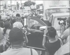  ??  ?? The crowd of supporters blocking Glenn Hanoman’s vehicle from leaving the court yesterday