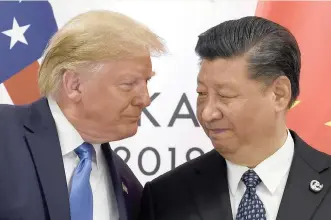  ?? | AP ?? US PRESIDENT Donald Trump and Chinese President Xi Jinping during a meeting on the sidelines of the G20 summit in Osaka, Japan, on Saturday. The US and China agreed to restart trade talks after Trump offered concession­s, including no new tariffs and an easing of restrictio­ns on tech company Huawei, in order to reduce tensions with Beijing. China agreed to make unspecifie­d new purchases of US farm products and return to the negotiatin­g table.