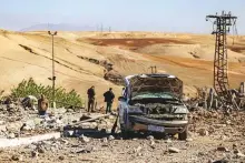  ?? AP ?? People inspect a site damaged by Turkish air strikes in the village of Taql Baql, in Hasakeh province, Syria, yesterday.